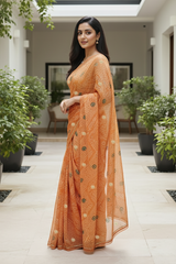 Woman in an Bandhej saree by Umaid Couture standing in a well-lit indoor setting with plants.