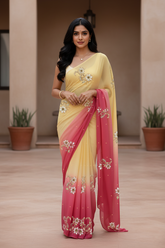 Woman wearing a yellow and pink saree by Umaid Couture with floral patterns indoors.