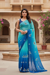 Woman standing in front of an architectural background wearing a gradient Blue saree embellished with Peacock motifs by Umaid Couture