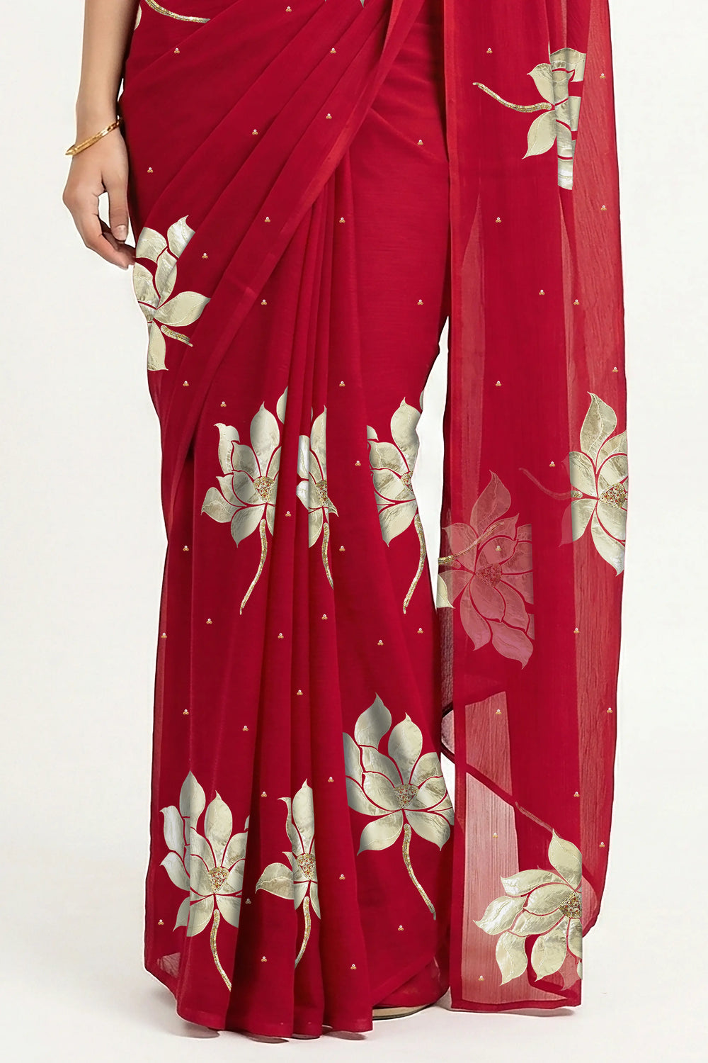 An Indian woman in Red Padma Saree embellished with Blooming lotus flowers made of Gota, Zari & sequins by craft of Aari-Zardosi, a product of Umaid Couture
