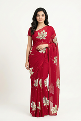 An Indian woman in Red Padma Saree embellished with Blooming lotus flowers made of Gota, Zari & sequins by craft of Aari-Zardosi, a product of Umaid Couture