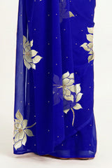 An Indian woman in blue Padma Saree embellished with Blooming lotus flowers made of Gota, Zari & sequins by craft of Aari-Zardosi, a product of Umaid Couture