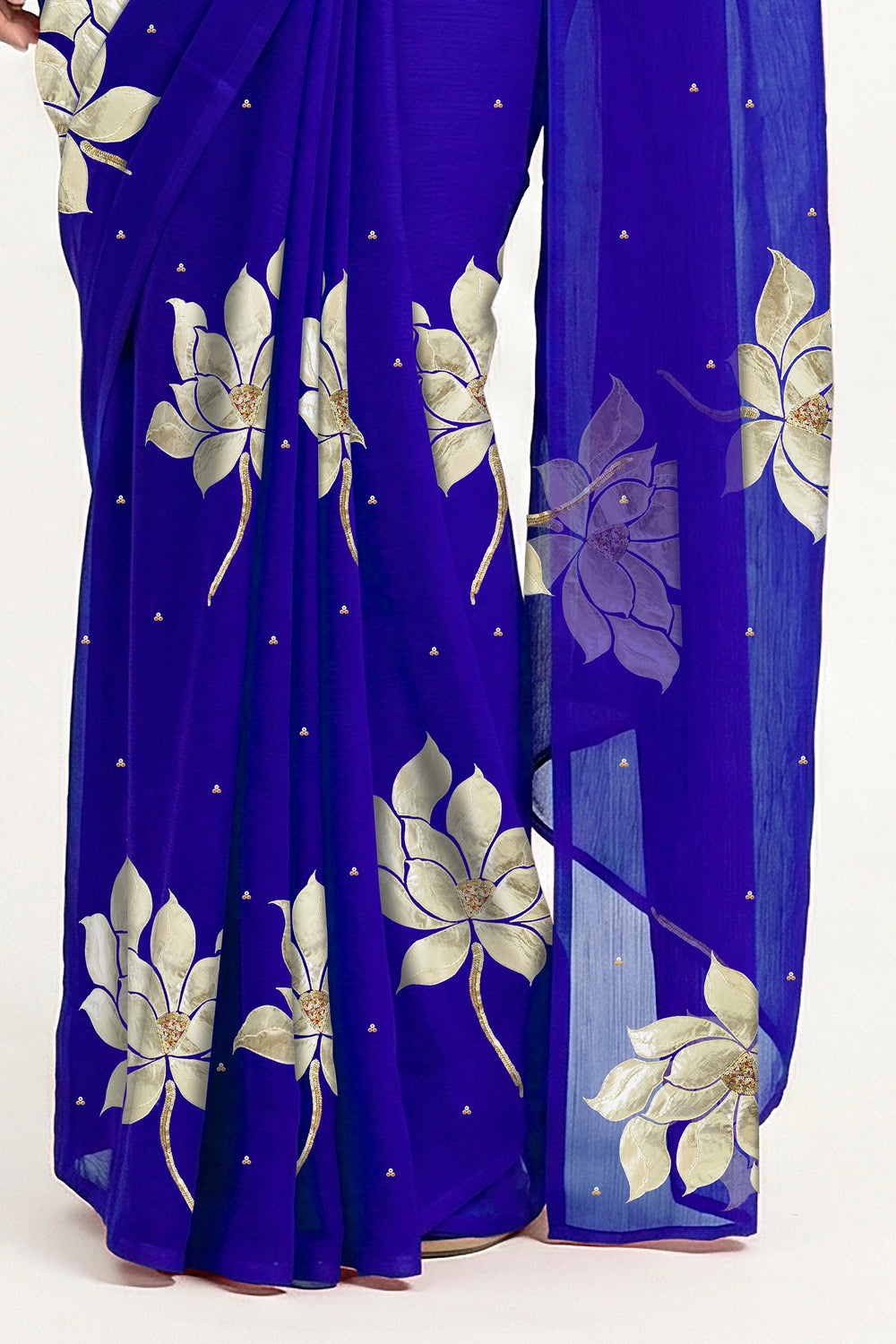 An Indian woman in blue Padma Saree embellished with Blooming lotus flowers made of Gota, Zari & sequins by craft of Aari-Zardosi, a product of Umaid Couture