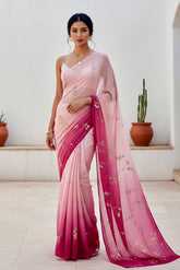 Woman wearing a pink and magenta sequins embroidered saree by Umaid Couture with a white background