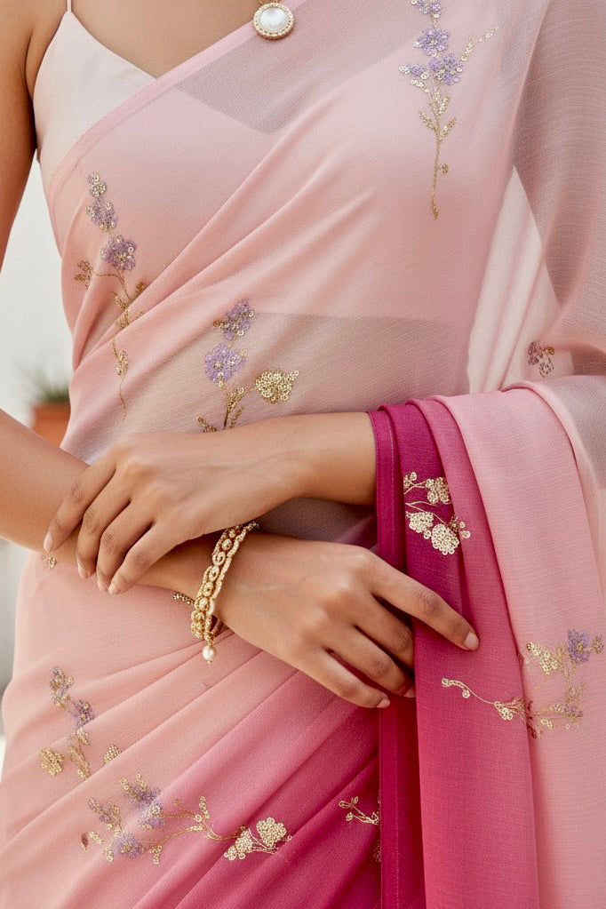 Woman wearing a pink and magenta sequins embroidered saree by Umaid Couture with a white background