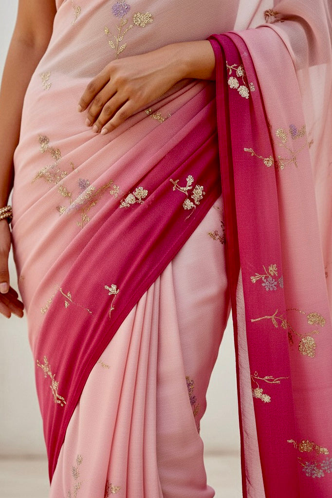 Woman wearing a pink and magenta sequins embroidered saree by Umaid Couture with a white background