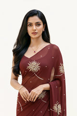 An Indian Woman in dark chocolate color saree embellished with Shevanti flower Motifs made of Gota, Zari and Sequins by Umaid Couture