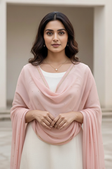 Woman wearing a pink Dupatta over a white outfit with a neutral background. product by Umaid Couture