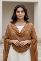 Woman wearing a brown scarf over a white top with a neutral background. product by Umaid Couture