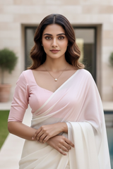 Woman wearing a pink blouse and white saree outdoors. product by Umaid Couture