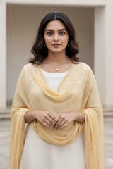 Woman wearing a dupatta over a white outfit by Umiad Couture with a neutral background
