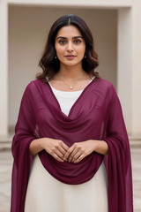 Woman wearing a purple scarf over a white top and skirt, standing indoors. Product by Umaid Couture.
