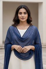 Woman wearing a blue scarf with a neutral background. product by Umaid Couture