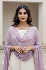 Woman wearing a light purple scarf over a white outfit with a neutral background. product by Umaid Couture