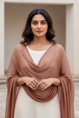 Woman wearing a brown scarf over a white top with a neutral background. Product by Umaid Couture