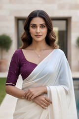 Woman wearing a white saree with a purple blouse in an outdoor setting. product by Umaid Couture