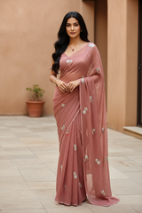 Woman in a Off-Bronze Art Drape Saree saree by Umaid Couture standing against a beige wall.
