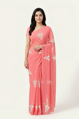 An Indian Woman in rose coral pink saree embellished with grape Motifs made of Gota, Zari and Sequins by Umaid Couture