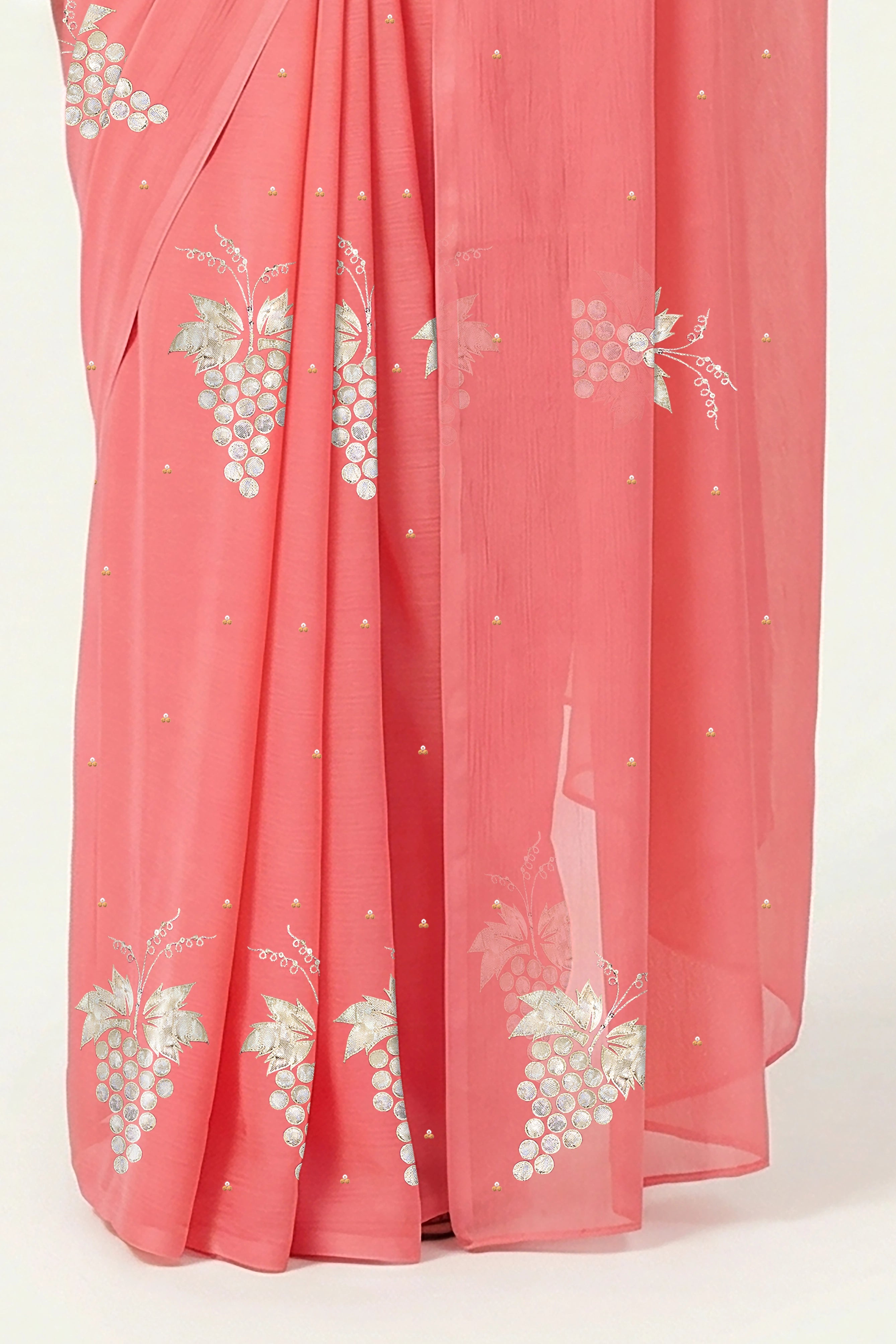 An Indian Woman in rose coral pink saree embellished with grape Motifs made of Gota, Zari and Sequins by Umaid Couture