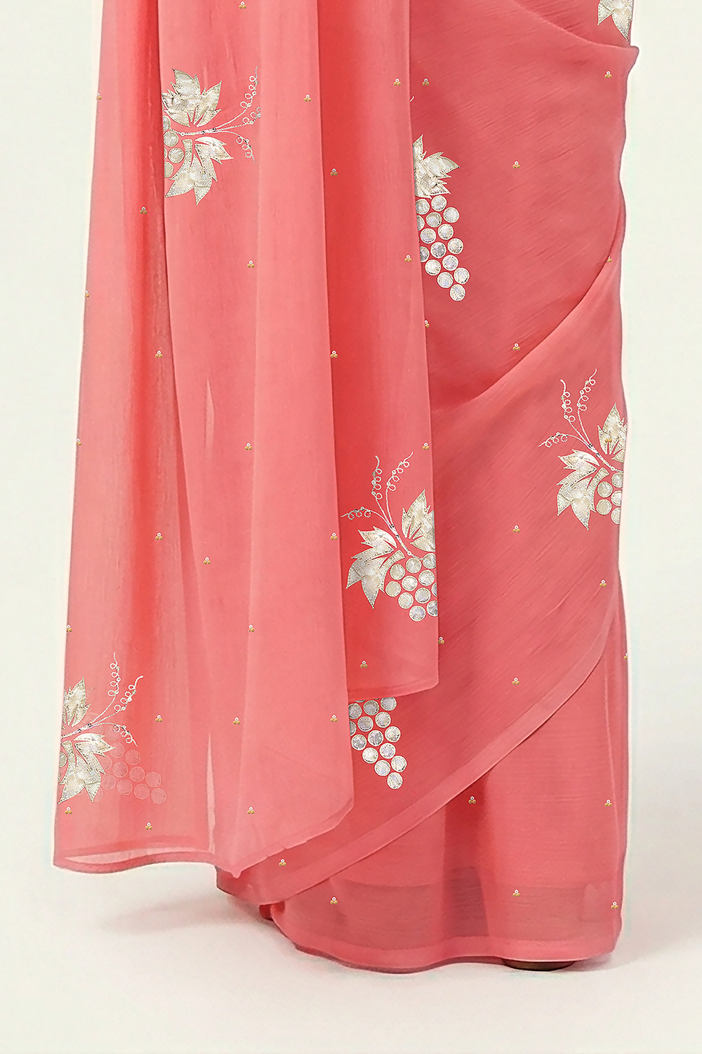 An Indian Woman in rose coral pink saree embellished with grape Motifs made of Gota, Zari and Sequins by Umaid Couture