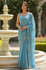 Model wearing Pearl Whispers Saree by Umaid Couture in shade of Blue standing in a garden Courtyard