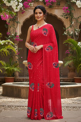 A model wearing a red peacock motifs saree by Umaid Couture standing in a Garden Courtyard.
