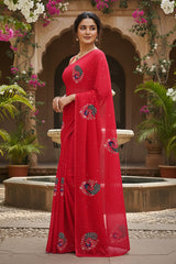 A model wearing a red peacock motifs saree by Umaid Couture standing in a Garden Courtyard.
