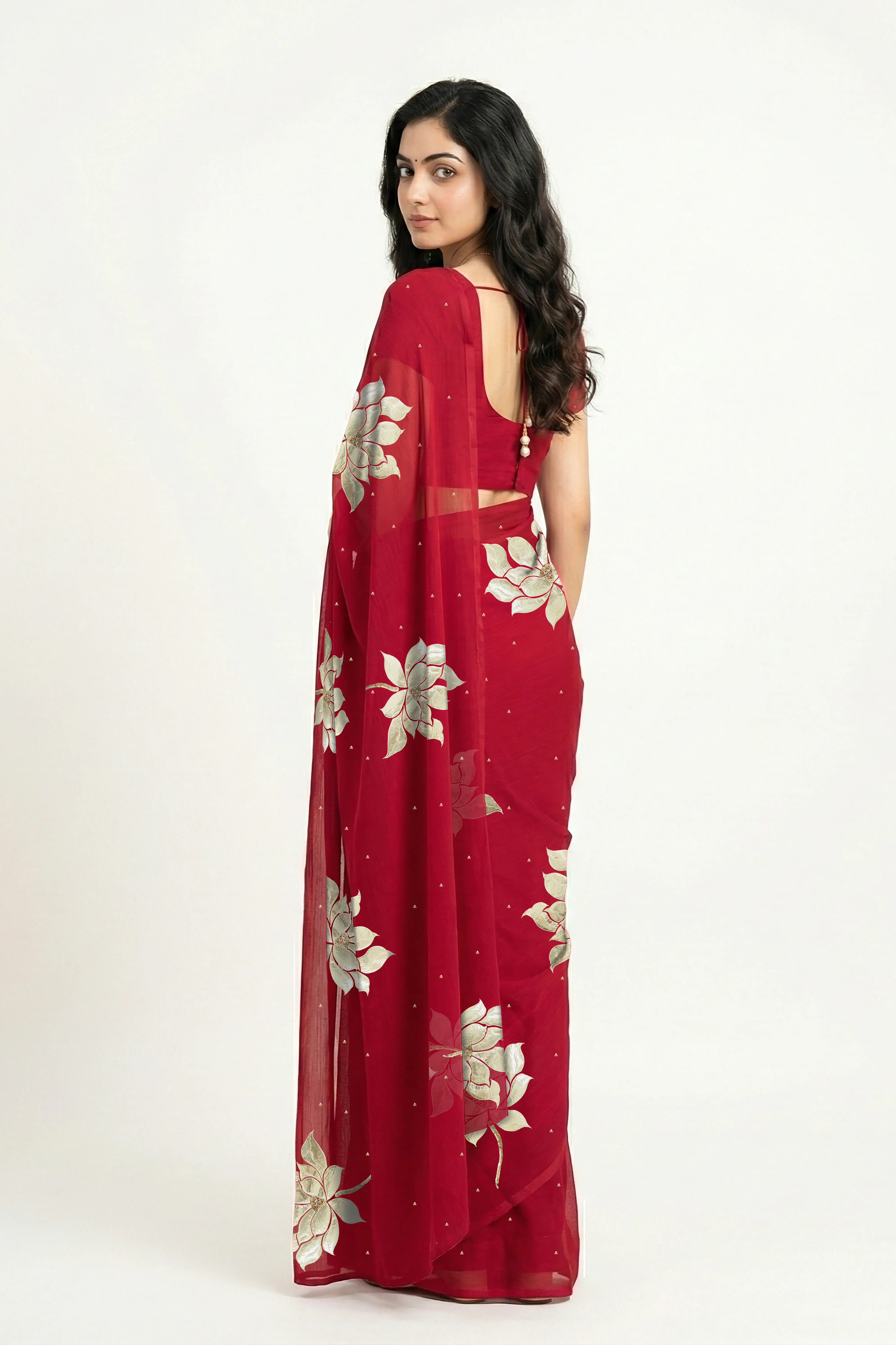 An Indian woman in Red Padma Saree embellished  with Blooming lotus flowers made of Gota, Zari & sequins by craft of Aari-Zardosi, a product of Umaid Couture