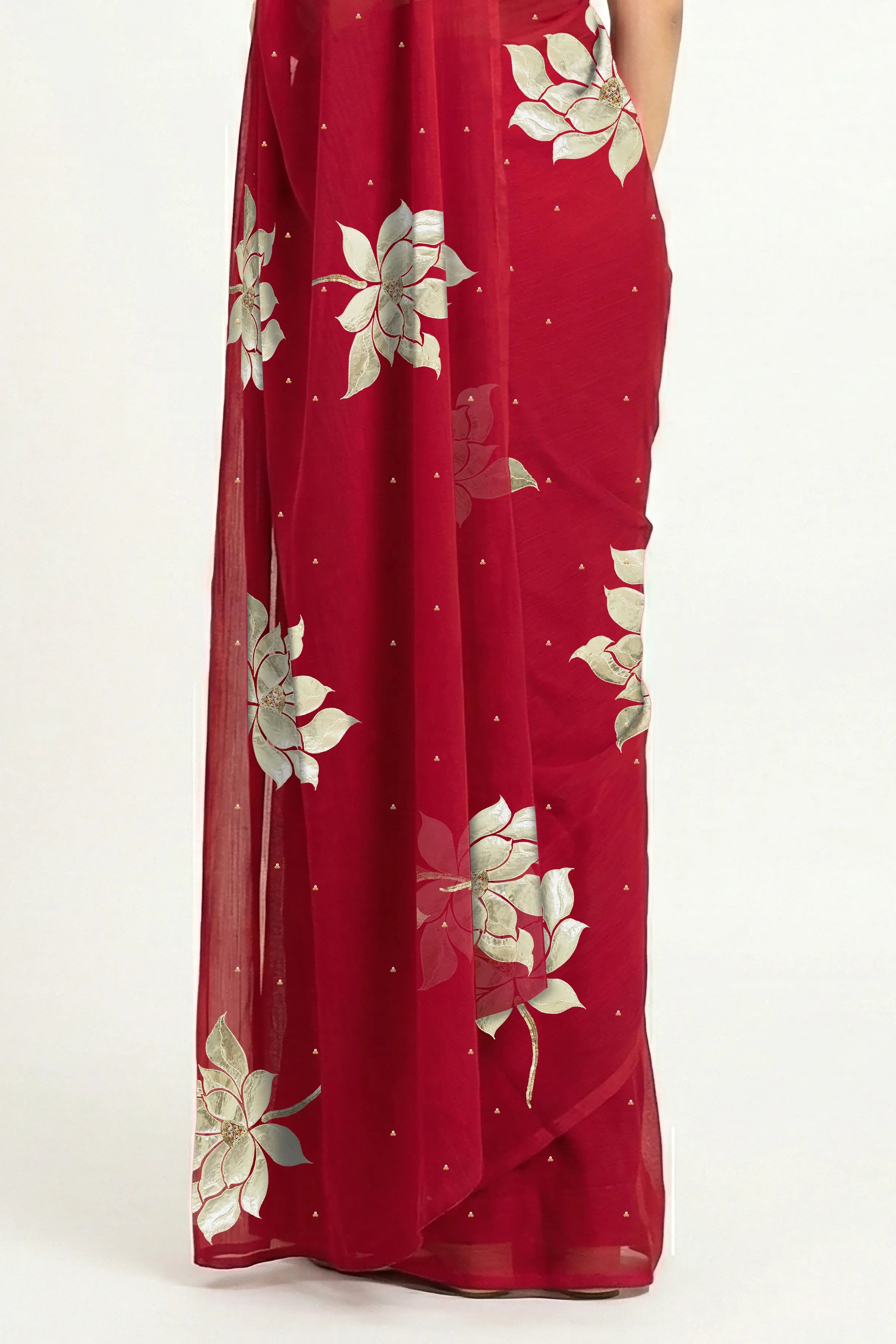 An Indian woman in Red Padma Saree embellished  with Blooming lotus flowers made of Gota, Zari & sequins by craft of Aari-Zardosi, a product of Umaid Couture