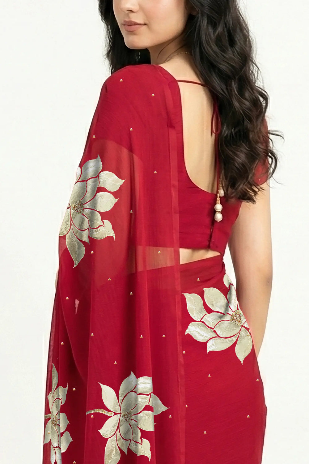 An Indian woman in Red Padma Saree embellished  with Blooming lotus flowers made of Gota, Zari & sequins by craft of Aari-Zardosi, a product of Umaid Couture