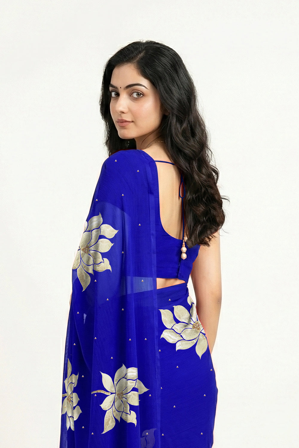 An Indian woman in blue Padma Saree embellished  with Blooming lotus flowers made of Gota, Zari & sequins by craft of Aari-Zardosi, a product of Umaid Couture