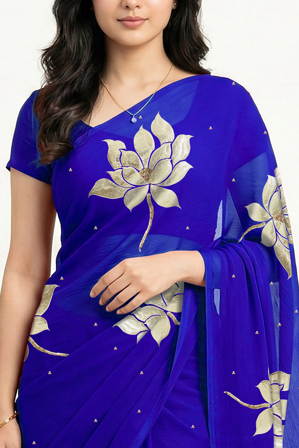 An Indian woman in blue Padma Saree embellished  with Blooming lotus flowers made of Gota, Zari & sequins by craft of Aari-Zardosi, a product of Umaid Couture