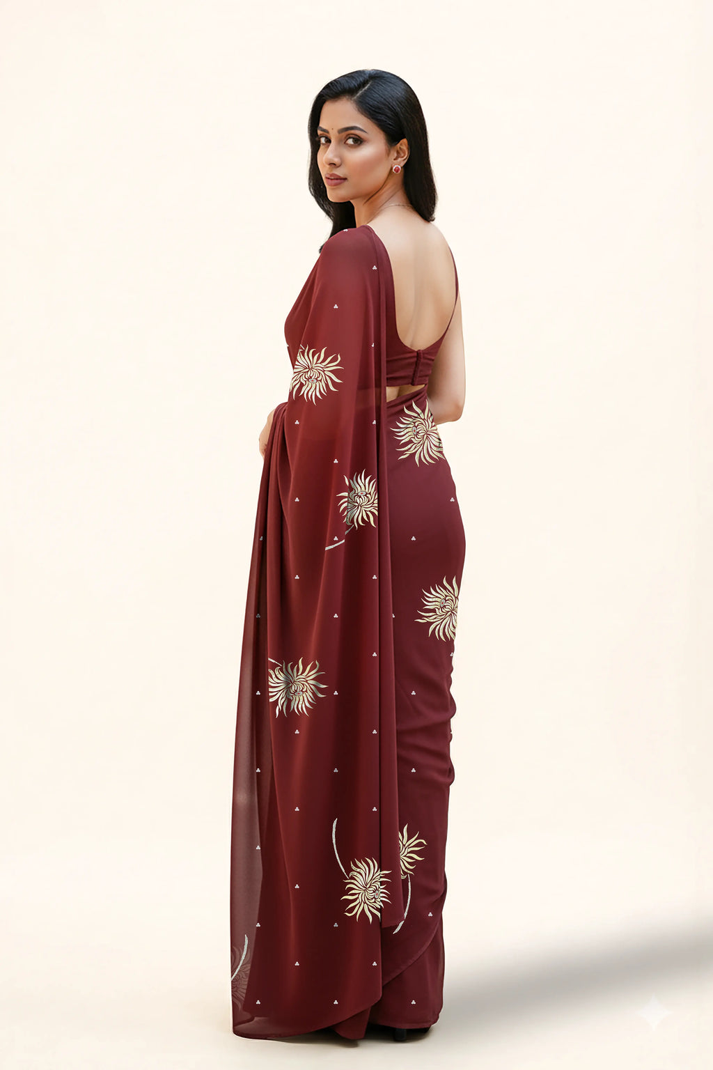 An Indian Woman in dark chocolate color saree embellished with Shevanti flower Motifs made of Gota, Zari and Sequins by Umaid Couture
