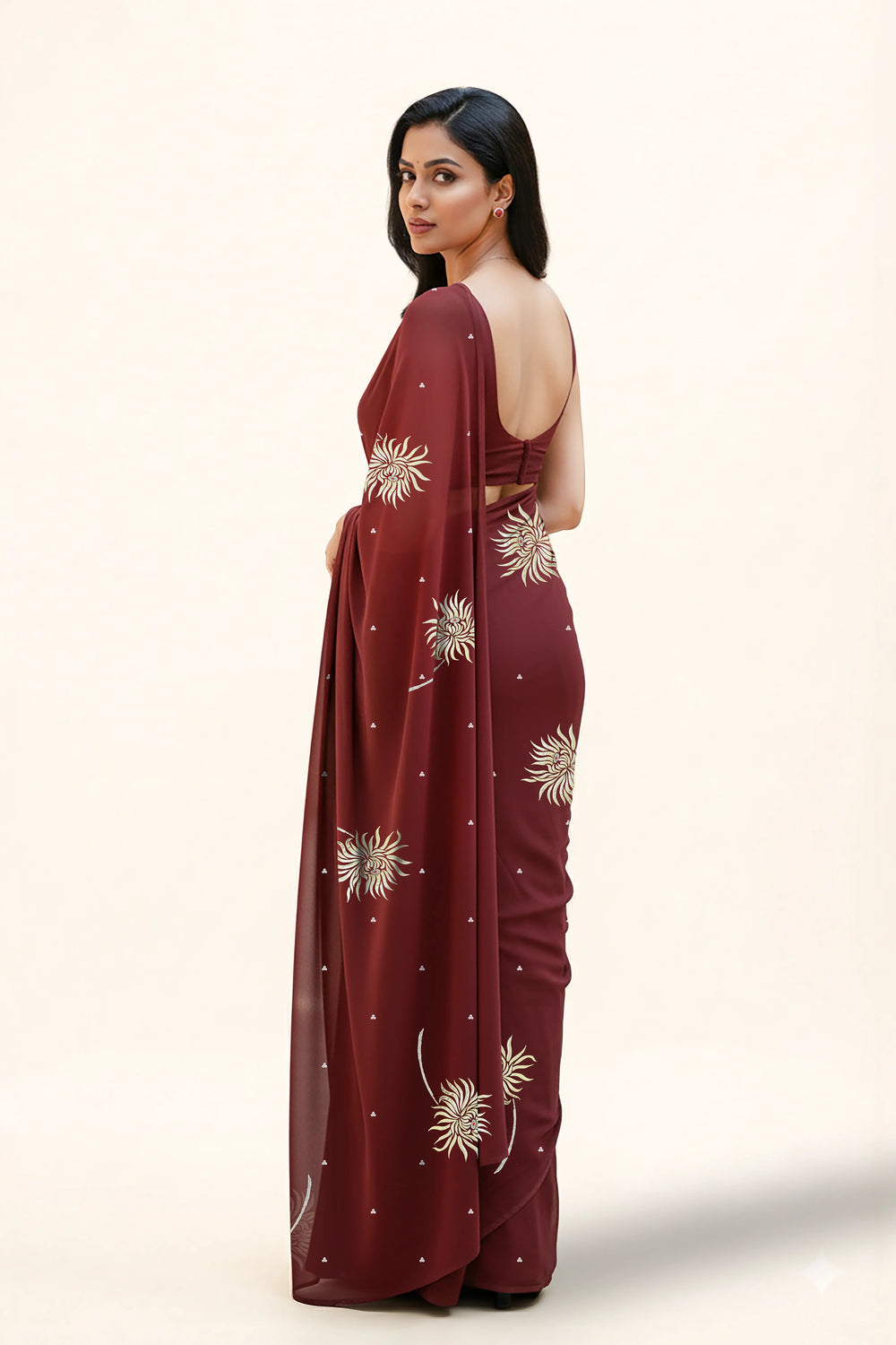 An Indian Woman in dark chocolate color saree embellished with Shevanti flower Motifs made of Gota, Zari and Sequins by Umaid Couture