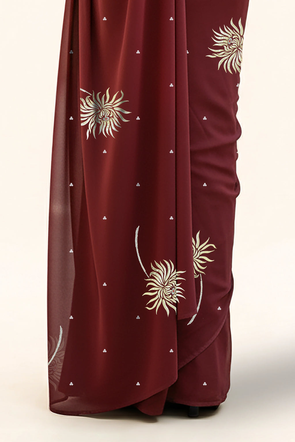 An Indian Woman in dark chocolate color saree embellished with Shevanti flower Motifs made of Gota, Zari and Sequins by Umaid Couture