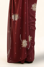 An Indian Woman in dark chocolate color saree embellished with Shevanti flower Motifs made of Gota, Zari and Sequins by Umaid Couture
