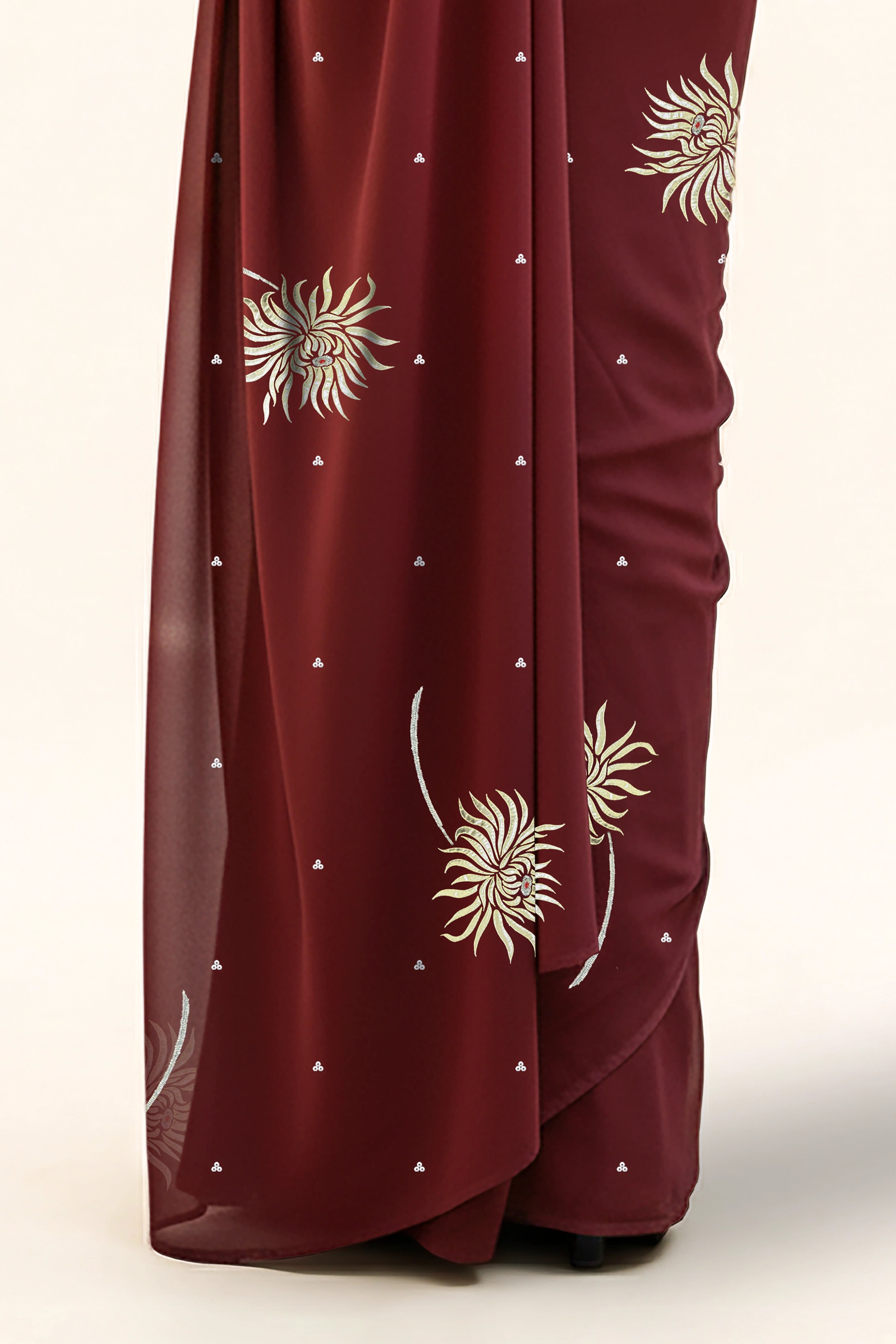 An Indian Woman in dark chocolate color saree embellished with Shevanti flower Motifs made of Gota, Zari and Sequins by Umaid Couture