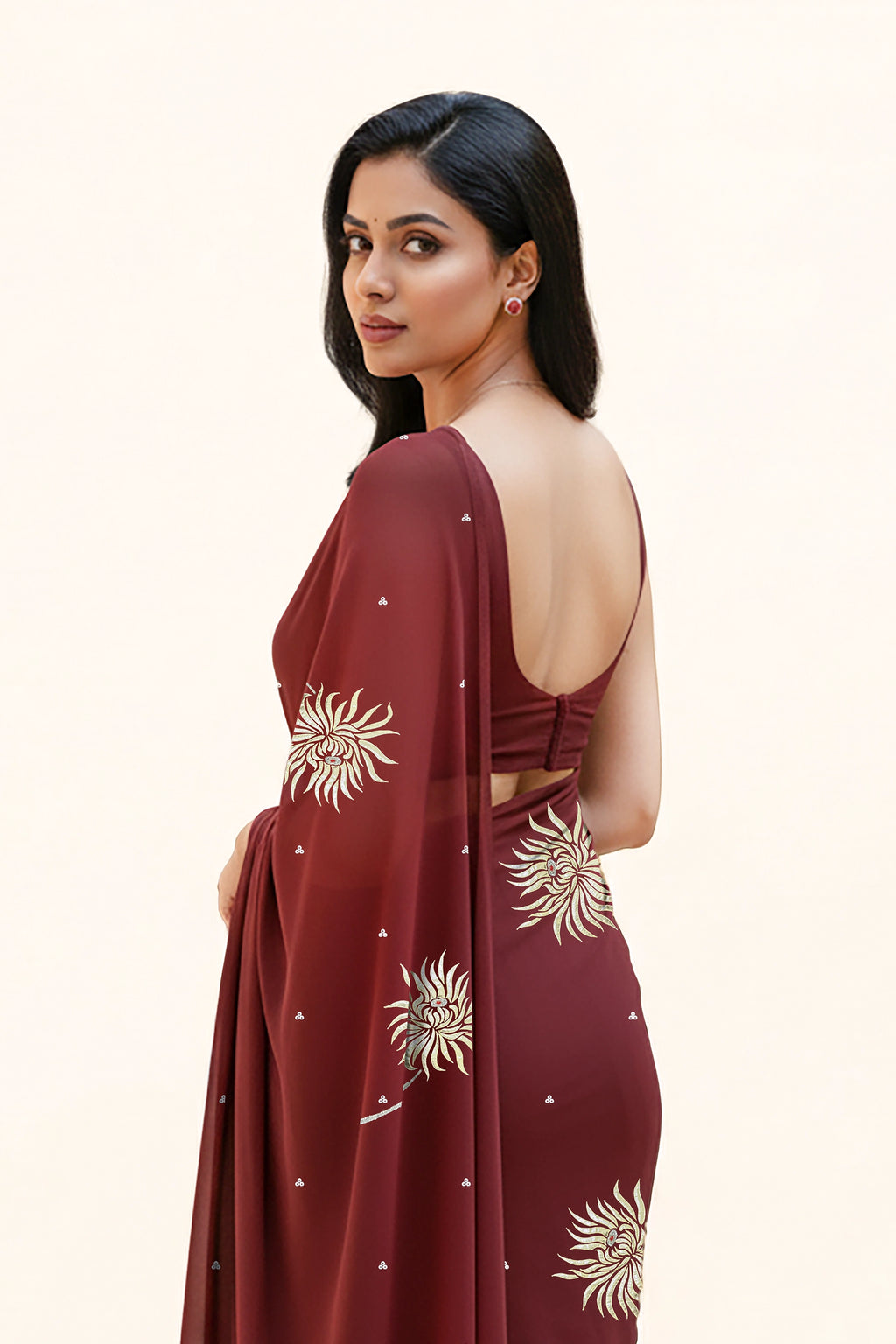 An Indian Woman in dark chocolate color saree embellished with Shevanti flower Motifs made of Gota, Zari and Sequins by Umaid Couture