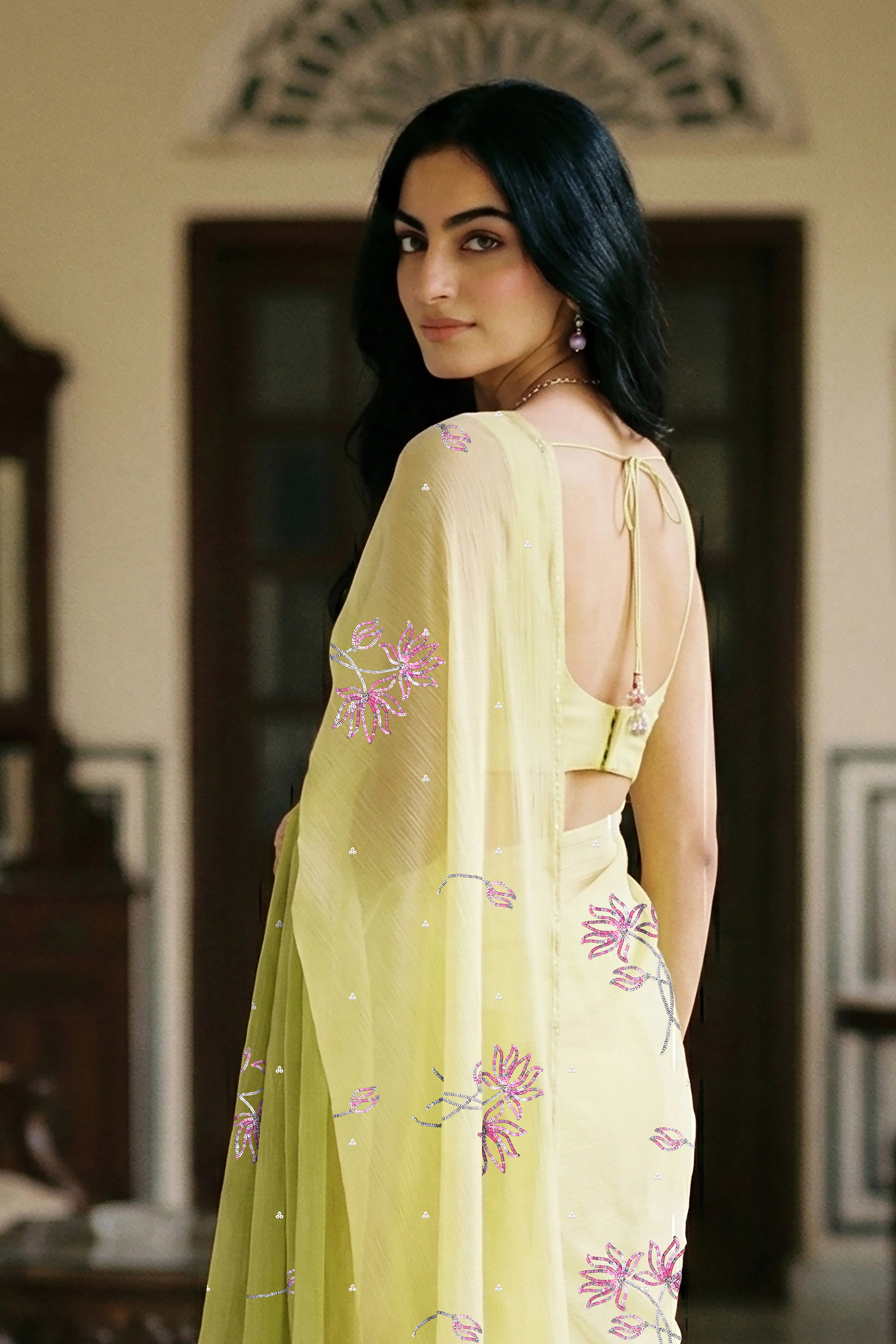 woman in green gradient saree with beautiful lotus motif made with pink and silver sequins and finely done with aari-zardosi made by umaid couture.