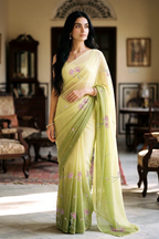 woman in green gradient saree with beautiful lotus motif made with pink and silver sequins and finely done with aari-zardosi made by umaid couture.
