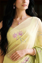 woman in green gradient saree with beautiful lotus motif made with pink and silver sequins and finely done with aari-zardosi made by umaid couture.