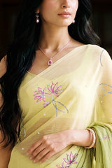 woman in green gradient saree with beautiful lotus motif made with pink and silver sequins and finely done with aari-zardosi made by umaid couture.