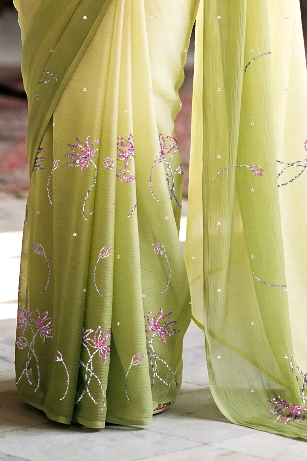 woman in green gradient saree with beautiful lotus motif made with pink and silver sequins and finely done with aari-zardosi made by umaid couture.
