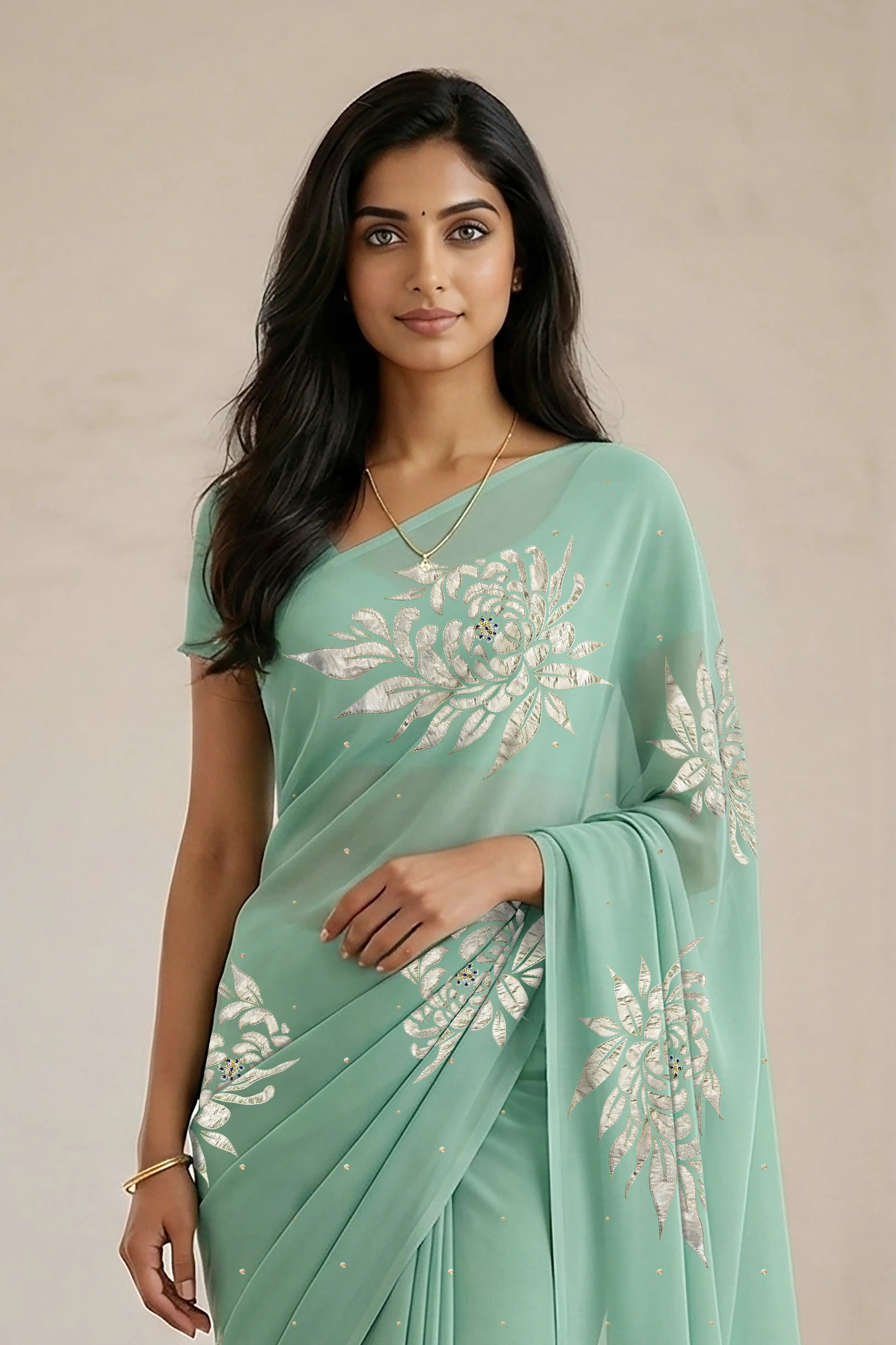 Woman wearing a light green saree with beautiful magnolia flower motif on it made by umaid couture.
