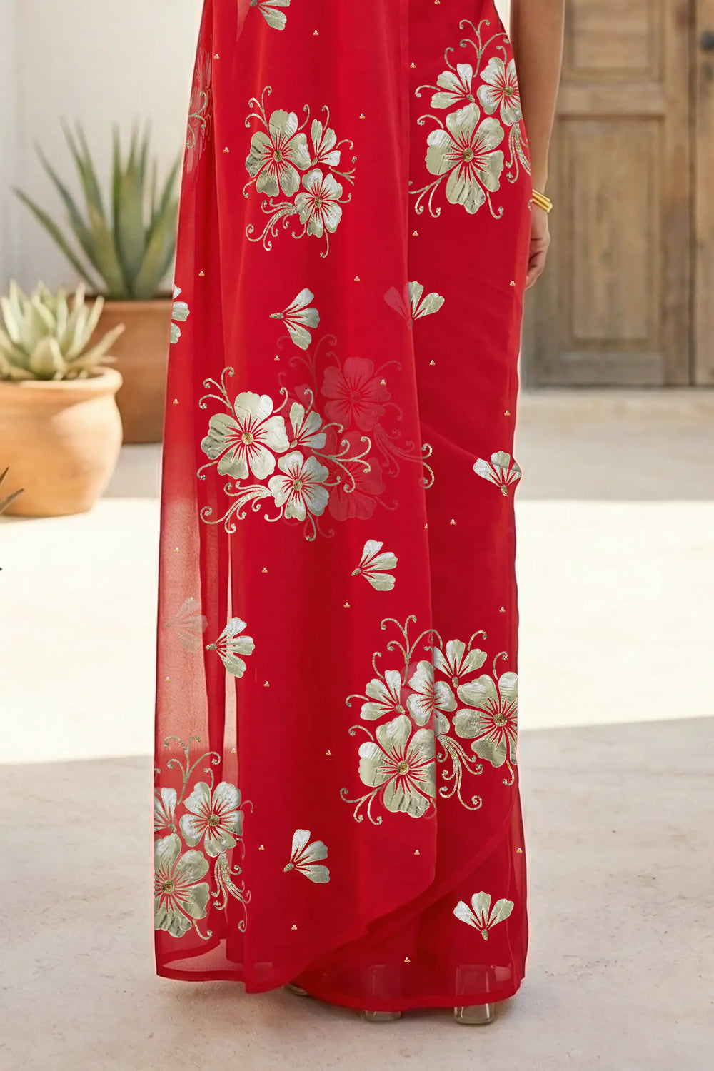 Model wearing a red Kusum Mulberry Silk  Chiffon saree embellished with Gota-Sequins Motifs by Umaid Couture