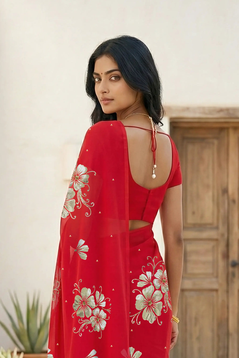 Model wearing a red Kusum Mulberry Silk  Chiffon saree embellished with Gota-Sequins Motifs by Umaid Couture