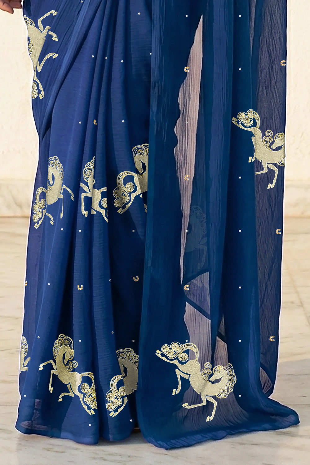 woman in Blue saree with silver golden sequins unicorn motif designs saree and finely work done with aari-zardosi  made by umaid couture.
