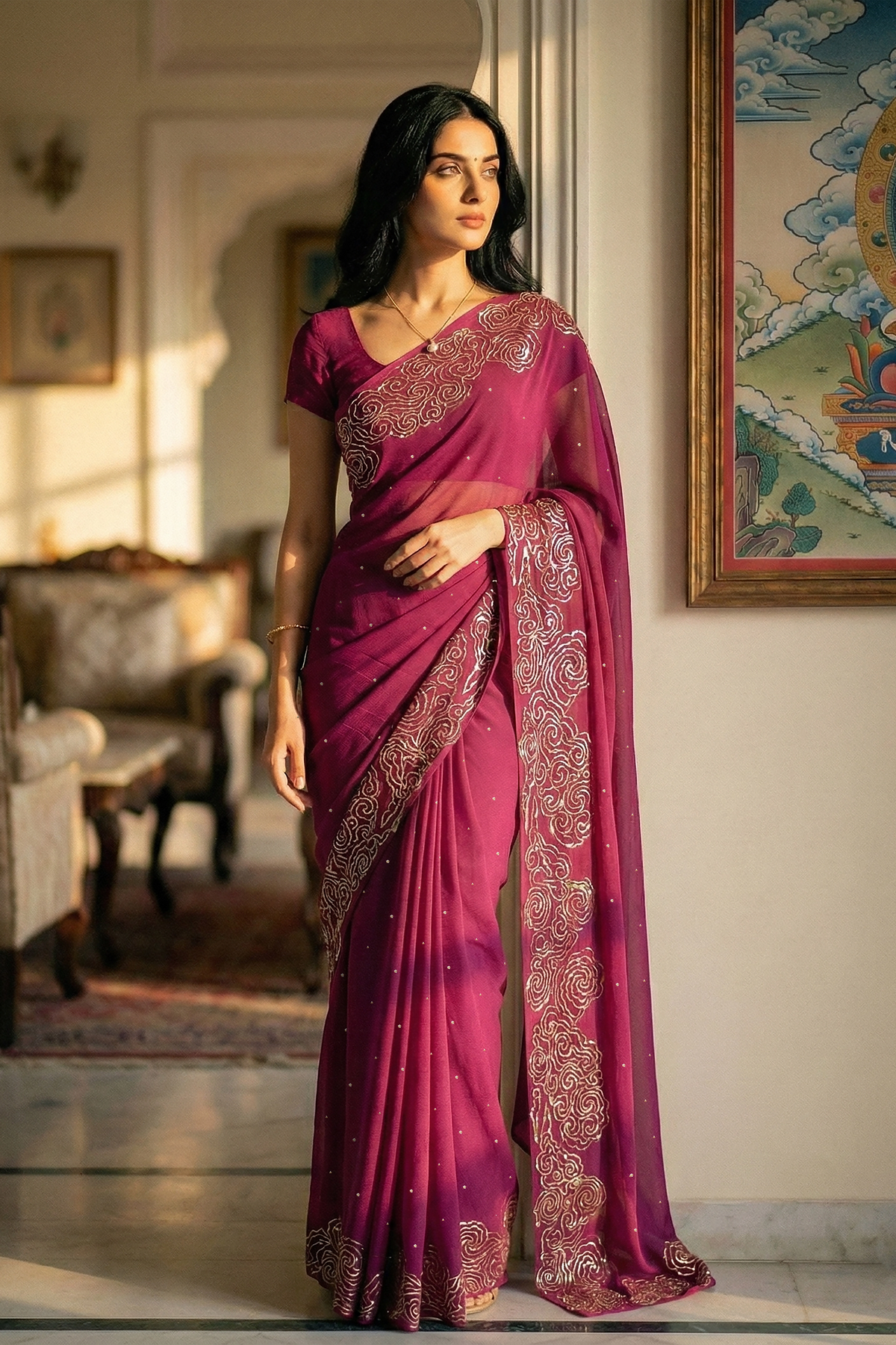 Woman in mulberry red saree with artistic cloud vines border on saree made by umaid couture.