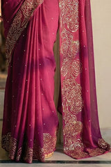 Woman in mulberry red saree with artistic cloud vines border on saree made by umaid couture.