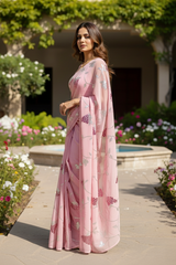 An Indian Model wearing a pink Grape vine saree by Umaid Couture, standing in a garden courtyard